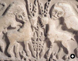 A detail from an Arab water trough at the Alhambra Museum shows the common royal motif of lions attacking their prey.