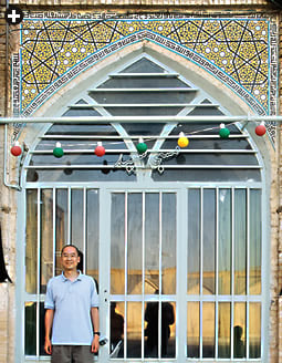 Physicist Peter J. Lu stands beneath tile spandrels at the Darb-i Imam shrine in Isfahan, Iran.