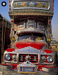 A gaudy goliath of the Great Trunk Road features, amoung other decorations, a painting of the Ka'bah at Makkah above the driver's cab. 