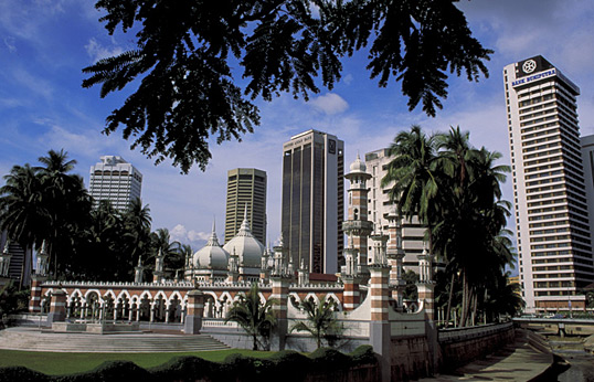 The threetop-level onion domes and ornate minarets of Jakarta's Jami'Masjid contrast sharply with the city's hard-edged skyscrapers. 