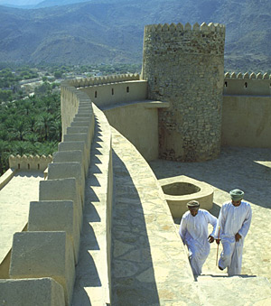 Young Omanis relax in the cool shade of the recently restored Restaq Fort. 