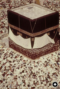 The Ka'bah, spiritual center of the Islamic world, toward which Muslims turn to pray five times a day, is an ancient stone structure about 17 meters (55 feet) high, roughly cubical in shape. It is customarily washed each year by Saudi Arabia's king. The kiswah that covers the Ka'bah, and a black cloth on which Qur'anic verses are embroidered in gold, is replaced every year. 