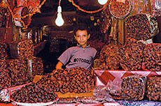 In Sana’a, Yemen, a young vendor sells dates imported from Saudi Arabia. All are sorted and priced by variety and ripeness. 