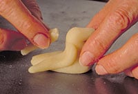 An artisan begins to shape a marzipan bird, much as da Vinci may have done for his patrons.