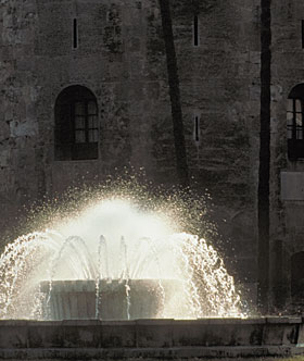 An illuminated fountain in front of Seville’s Torre del Oro, or Golden Tower. Begun in 1220 and covered with gold luster tiles, it is the last major Almohad work built in Seville.
