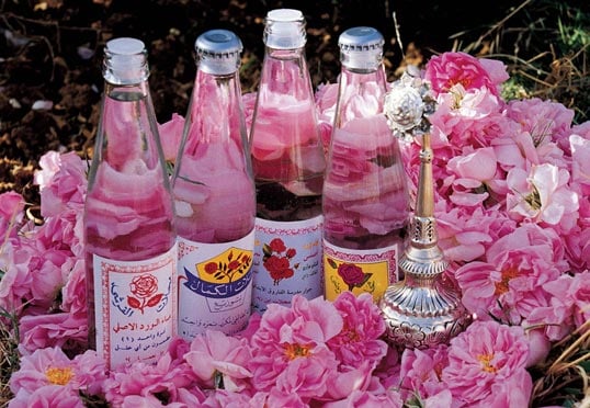 Several of the Taif-area rose distilleries market their own brands of rose water, shown here with a traditionally shaped hand-held silver sprinkler.