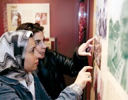 Visitors scrutinize displays that have drawn from more than 500 personal and family artifact donations nationwide.
