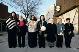 Seven women who came to the museum's opening by bus from Chicago pose on the street before heading home.