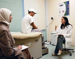 Hisam Ajouz, 17, gets a pre-football season checkup from Leila Hadda, MD, at the ACCESS health clinic.