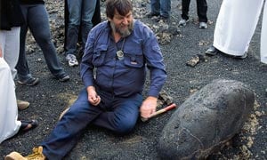 Mapping the harraat was "one of the last great challenges left on earth," says volcanologist and SGS advisor John Roobol. "This was total geology." Here, he shows a basalt "bomb" that was ejected during an eruption.