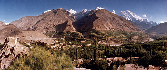 Overlooked by the shining slopes of Rakaposhi, which rise nearly 6000 meters (19,200') from the valley floor, the apricot orchards and wheat fields of the Hunza Valley wind along the Hunza River.
