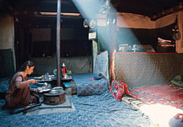 A woman uses a wood-fueled stove inside her home in the town of Karimabad. 