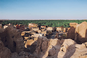 Home to some 300,000 date palms and one-tenth as many people, Siwa lies 300 kilometers (185 mi) from Mersa Matruh, the nearest town. A road first connected the two in the mid-1980’s. Heavy rains “melted” the old town, foreground, in 1926.