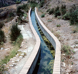 Flowing toward Granada from the spring in the village of Alfucar in the foothills of the Sierra Nevada, an acequia first built in the 13th century still flows today.