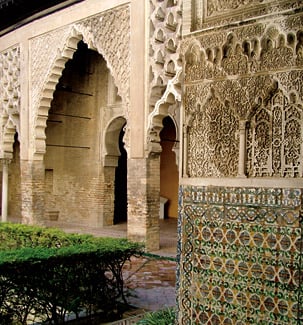 Pedro’s name is inscribed on the façade of his palace above tilework by Muslim mudejar artisans: an inscription in stylized “mirrored Kufic,” which is reflected on either side of the centerline of this image.
