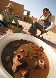 In the compound that houses the DOP, local workers wash artifacts. 