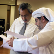 Tarek Hosni, editor-in-chief at Teshkeel, consults with Al-Mutawa.