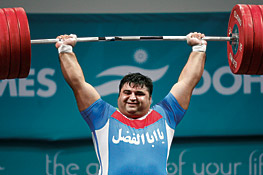 Iran’s Hossein Reza Zadeh lifts 230 kilos (506 lbs) during the weightlifting competitions to win one of his country’s 48 gold medals.