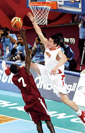 China’s forward Zhu Fangyu helps his team beat Qatar in the men’s basketball final. 