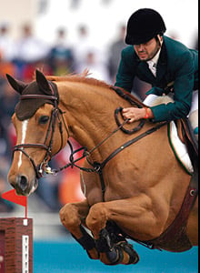 Khalid Al ‘Eid of Saudi Arabia clears an obstacle on his horse Al-Riyadh to secure the gold for his equestrian team.