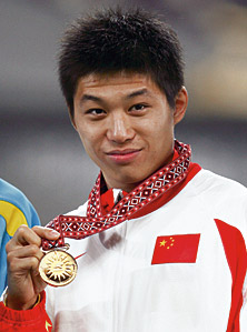 Li Yanxi of China poses with his gold medal, won in the triple jump. China took 316 gold medals during the Asian Games. 