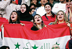 Iraq supporters cheer on their team during the final game. 