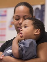 The face of Noelle Levingston shows concern for her son Devin, 3, while they sit in the waiting room.