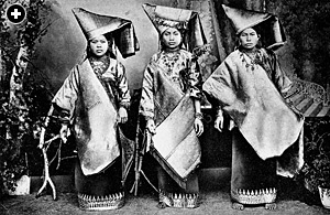 In a photograph from the early 20th century, three women from the ruling class of Sumatra, Indonesia’s largest island, wear brocade-like songket shoulder cloths and headdresses that glisten with gold and silver thread.