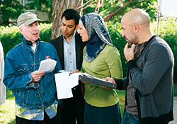 Director Michael Kennedy confers on the set with actors Zaib Shaikh, Sitara Hewitt and Carlo Rota.
