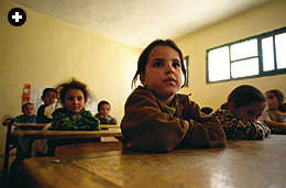 Youngsters attend class in Taghia’s school, refurbished as a cooperative project by village families and The North Face climbers.