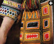 Fine embroidery decorates the cuff and side panel of a costume from the Taif region.