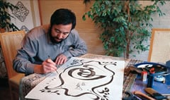 “Arabic calligraphy in Chinese style is the crystal of collected wisdom from countless ancestors,” says Hajji Noor Deen Mi Guangjiang, shown here at work in his studio.