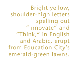 Bright yellow, shoulder-high letters spelling our Innovate and Think in English and Arabic