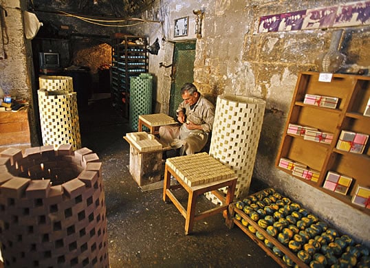 One handcrafted bar at a time, Mahmud al-Sharkass plies his trade at his family’s 200-year-old soap workshop in the Khan al-Masriyyin (Egyptians’ Khan) in Tripoli, Lebanon. He and his family make both bar soap—shown stacked in drying towers all around him—and “ball soap,” each ball shaped by hand, some in plain colors, and some marbled with two or more colors.