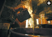 The first step in soap-making is to mix olive oil (at times mixed with laurel oil) with caustic soda and cook the mixture in a vat. The resulting paste is then smoothed onto a flat surface such as a large tray or a floor. It is then sliced into bars or shaped into balls and dried till it is ready for sale in shops or via the Internet.