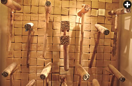 Soap stamps, each carrying its maker’s branding mark, hang in front of a soap wall at the Musée du Savon.