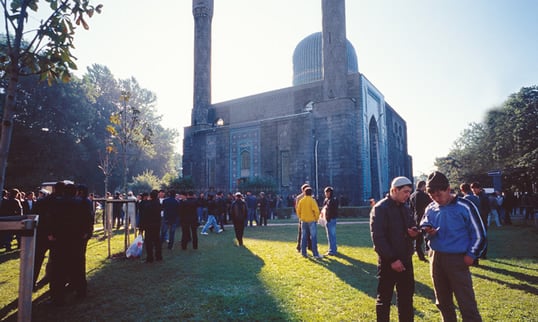 Men socialize on the grounds of the mosque on Friday after prayers.