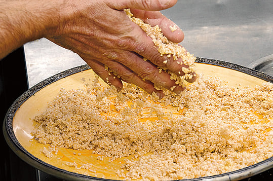 Winner of the festival’s culinary contest in 2006, local chef Domenico Castiglia prepares one of his gourmet seafood couscous dishes by first hand-rolling durum wheat into tiny grains.