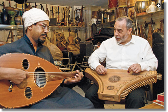 Echoing the Middle Ages from his Madrid studio, Eduardo Paniagua plays a psaltery, or lap harp, as longtime collaborator Wafir Sheikh el-Din plays an 'ud, or fretless lute. Iberian predecessors include these frieze figures, opposite, from Santiago de Compostele, Spain, and the illustration, below, that Paniagua chose for the cover of one of his most popular recordings, "The Best of the Cantigas."