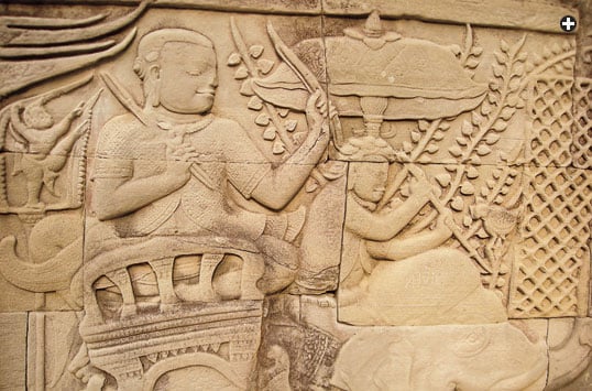 Hindus, too, adopted the umbrella in both religious and royal settings. At Angkor, Cambodia, a statue above depicts the Hindu god Vishnu, and a relief detail, below, depicts a battle in which a ruler fights from beneath an umbrella. 