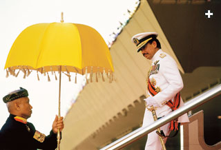 In modern times, Sultan Hassanal Bolkiah of Brunei, above, used a yellow umbrella at a ceremony on his birthday, and a traditional ruler in Ghana, below, used several in his party for a corn festival parade in Accra. The large umbrellas in the background resemble the ones depicted in the early 19th century.