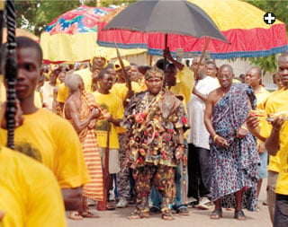 In modern times, Sultan Hassanal Bolkiah of Brunei, above, used a yellow umbrella at a ceremony on his birthday, and a traditional ruler in Ghana, below, used several in his party for a corn festival parade in Accra. The large umbrellas in the background resemble the ones depicted in the early 19th century.