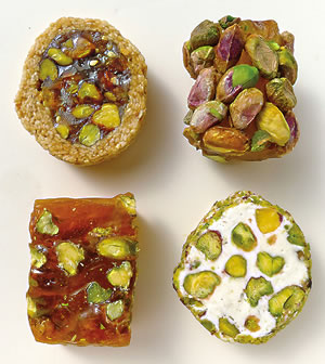 Pistachios have long been a favorite nut in sweets from the Middle East and Mediterranean. From top left, clockwise: Pistachios in jelled confection wrapped in toasted sesame seeds; whole pistachios over jelled sugar; chopped pistachios in nougat; chopped pistachios in sugar gel.