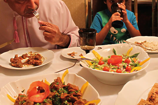 Dining on traditional fare that has been adapted to Oman from Baluchi origins, the Lashko family enjoys goat meat pan-fried with tomatoes and onions in an Omani spice mix heavy with black pepper, served with date chapati (flatbread) and a salad of local vegetables. 
