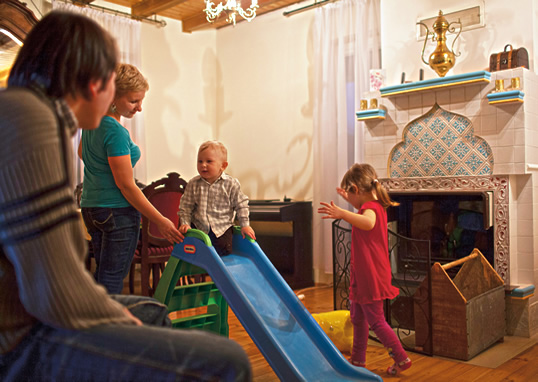 Dżemil and Kasia Gembicki, who are, respectively, Muslim and Catholic, play at home in Kruszyniany with their children. The couple explains they are raising Selim, left, Muslim, and Lilia Catholic.