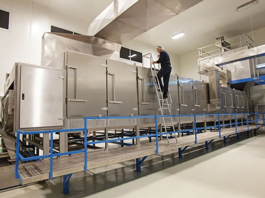 Another worker inspects the ovens that roast six tons of hazelnuts per hour.  