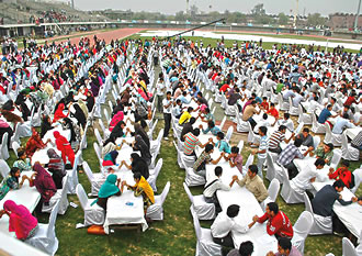 Guinness has honored claims of 32 records by the three-year-old Punjab Youth Festival in Lahore, Pakistan. Top: 1450 participants break the record for the Largest Number of People Simultaneously Arm Wrestling; above: Mohammad Rashid of Karachi kicks 50 coconuts off the heads of four courageous assistants.