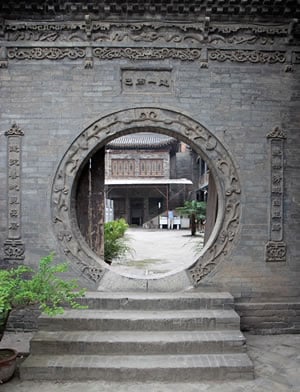 Offering both an entry and a frame for the view beyond it, a circular opening in a wall is known in China as a moon gate. A common feature in gardens, it was also used in religious architecture and, as we see here, in the wall at the Great Mosque of Xian. 