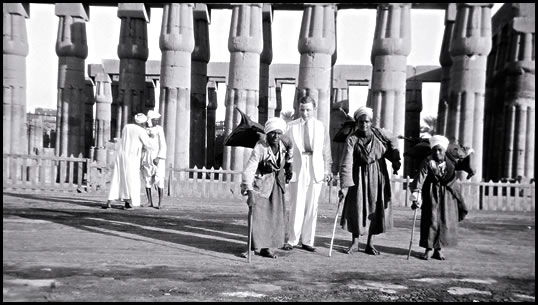 In Luxor, Gaddis also often photographed tourists, celebrities and royalty. Top: a western-clad tourist poses with local water-carriers in the Ramesseum, circa 1930s.