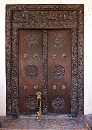 Stylistic testimony to Indian Ocean trade, a wooden door carved in vegetal rosettes and arabesques shows patterns that much resemble countless others from the Arabian Peninsula to India.